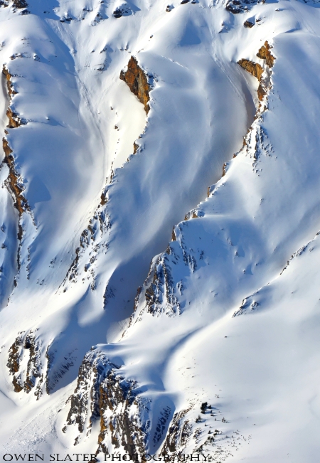 Serpentine red mountains, snow watermark